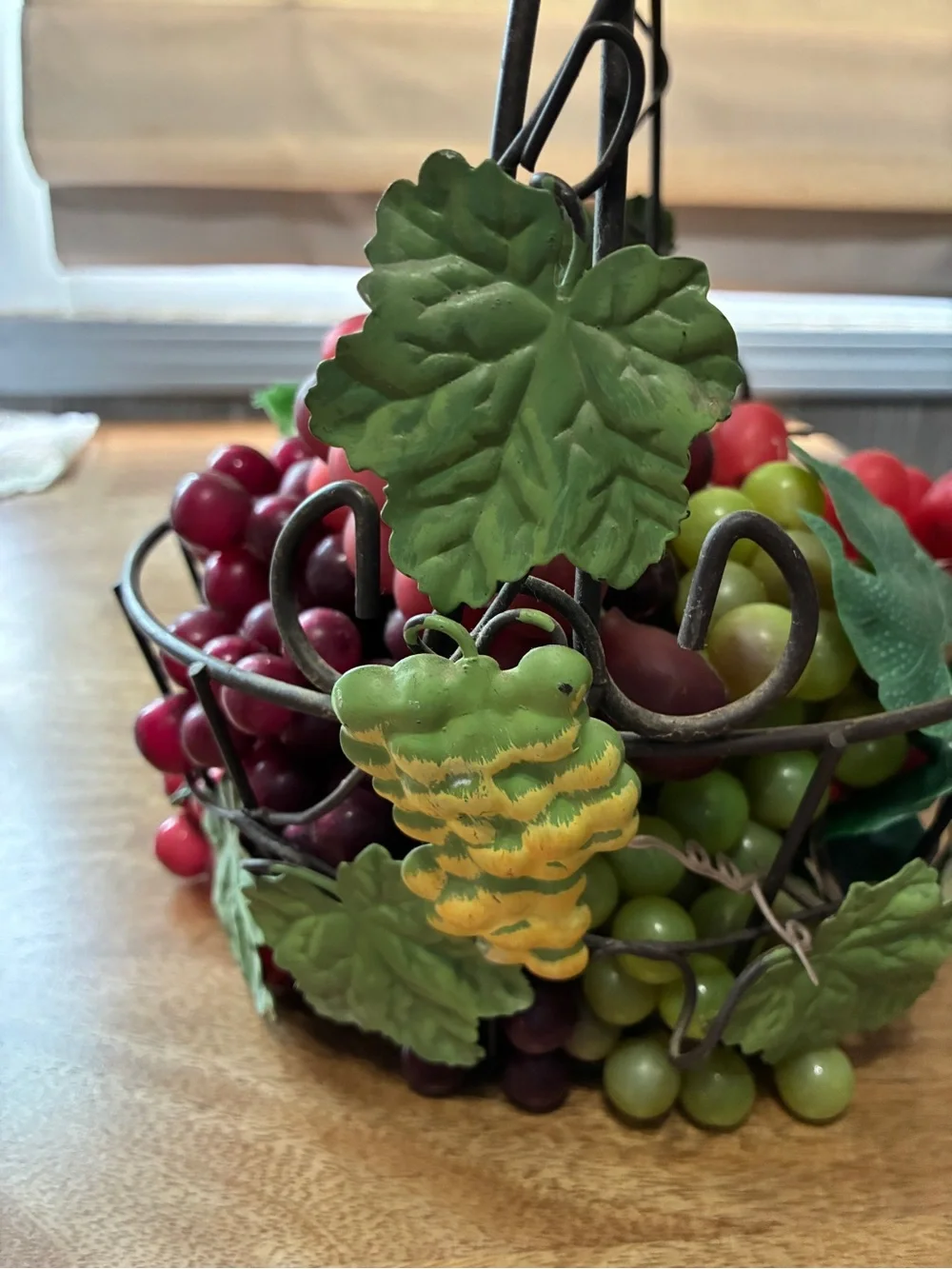 decorative artificial grape clusters, in a wire basket 8” x 10”